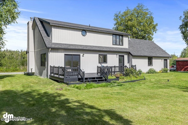 174 E Leota St, Wasilla, AK 99654 - back of property with a deck, a lawn, and a shingled roof