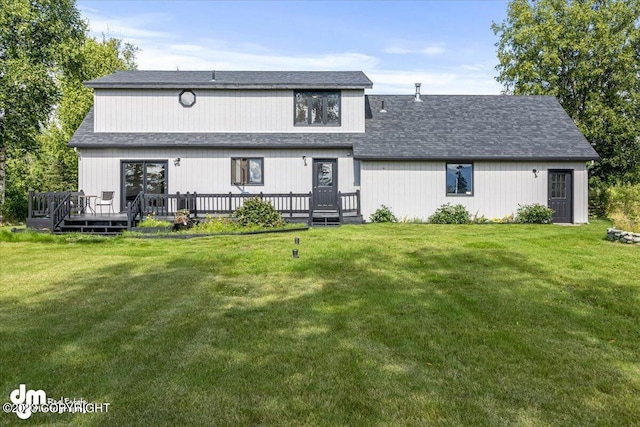 174 E Leota St, Wasilla, AK 99654 - rear view of property featuring a deck, a yard, and a shingled roof