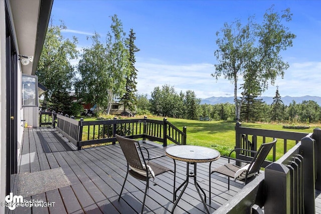 174 E Leota St, Wasilla, AK 99654 - wooden terrace featuring a mountain view and a yard
