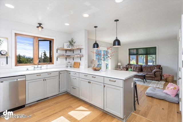 174 E Leota St, Wasilla, AK 99654 - kitchen featuring stainless steel dishwasher, gray cabinets, a sink, open floor plan, and a peninsula