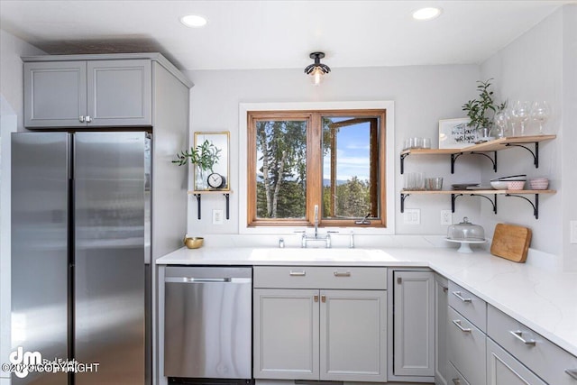 174 E Leota St, Wasilla, AK 99654 - kitchen with appliances with stainless steel finishes, a sink, gray cabinets, recessed lighting, and light stone countertops