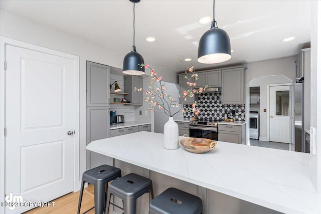 174 E Leota St, Wasilla, AK 99654 - kitchen with gray cabinets, stainless steel appliances, backsplash, light stone countertops, and recessed lighting