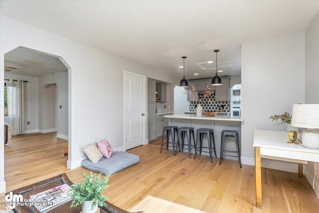 174 E Leota St, Wasilla, AK 99654 - living room with arched walkways, light wood finished floors, baseboards, and recessed lighting