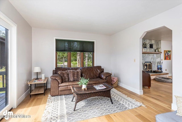 174 E Leota St, Wasilla, AK 99654 - living area featuring light wood finished floors, arched walkways, and baseboards