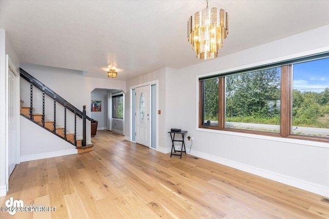 174 E Leota St, Wasilla, AK 99654 - entryway with a chandelier, light wood-type flooring, baseboards, and stairway
