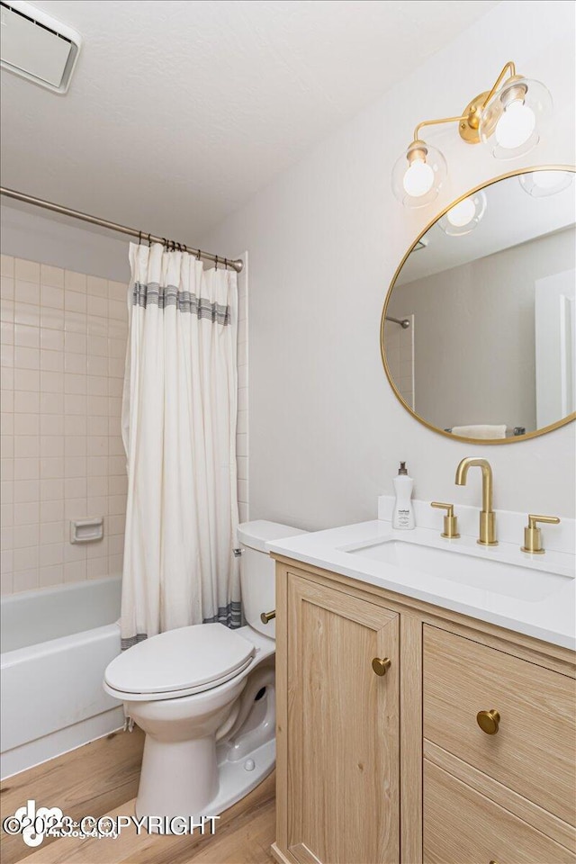 174 E Leota St, Wasilla, AK 99654 - bathroom with wood finished floors, toilet, vanity, and shower / bath combo with shower curtain