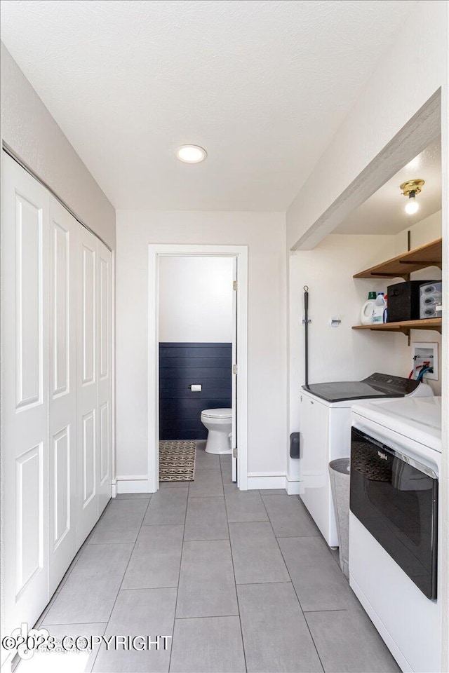 174 E Leota St, Wasilla, AK 99654 - kitchen featuring washing machine and clothes dryer, baseboards, light tile patterned flooring, recessed lighting, and white cabinetry