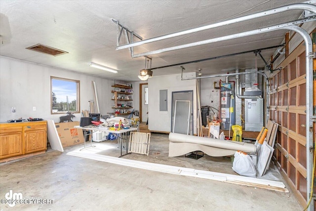 174 E Leota St, Wasilla, AK 99654 - garage featuring water heater, electric panel, and heating unit