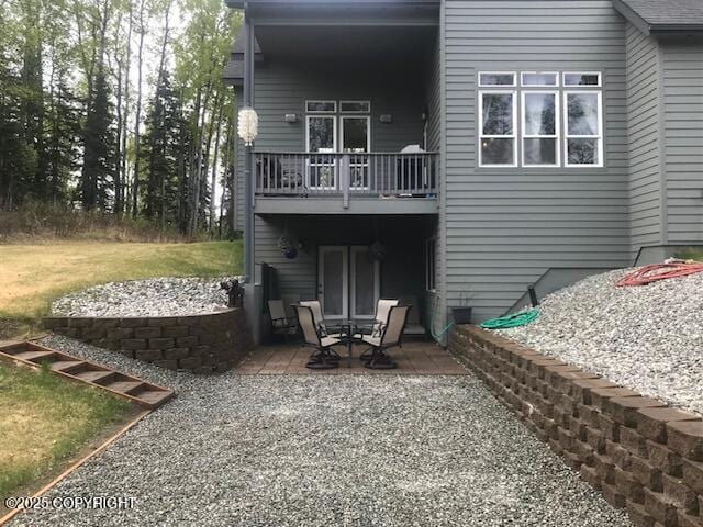 2295 N Filly Cir, Wasilla, AK 99654 - rear view of house featuring a patio area and a balcony