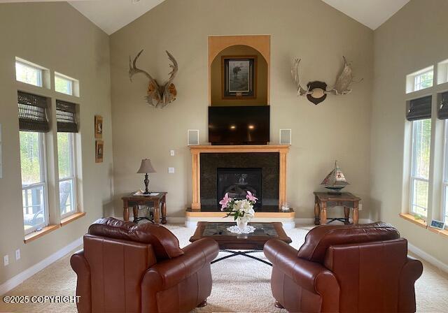 2295 N Filly Cir, Wasilla, AK 99654 - living room with carpet, baseboards, a glass covered fireplace, and high vaulted ceiling