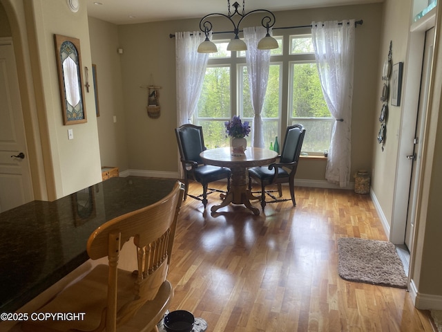 2295 N Filly Cir, Wasilla, AK 99654 - dining space featuring plenty of natural light, light wood-type flooring, and baseboards