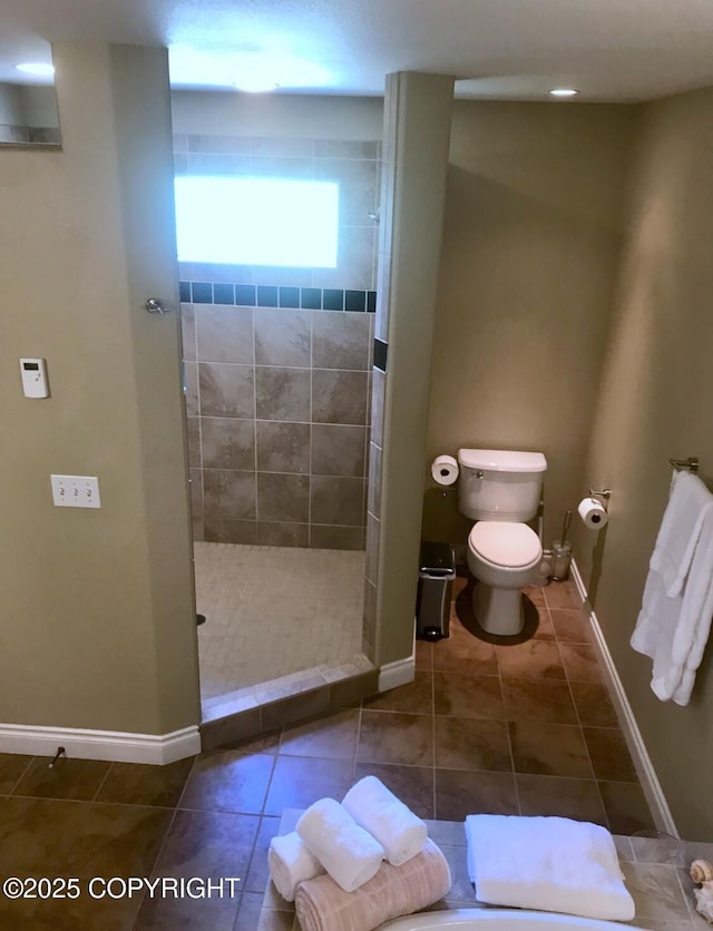 2295 N Filly Cir, Wasilla, AK 99654 - bathroom with a tile shower, baseboards, toilet, and tile patterned floors