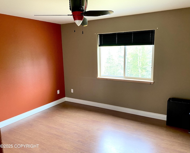 2295 N Filly Cir, Wasilla, AK 99654 - spare room featuring wood finished floors, a ceiling fan, and baseboards