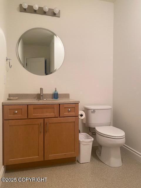 2295 N Filly Cir, Wasilla, AK 99654 - bathroom featuring baseboards, vanity, and toilet