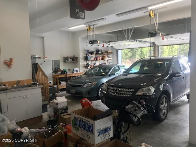 2295 N Filly Cir, Wasilla, AK 99654 - garage featuring a garage door opener and a sink