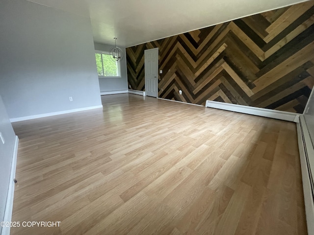 412 Pine Cir, Kenai, AK 99611 - unfurnished living room with a chandelier, wood finished floors, and baseboards