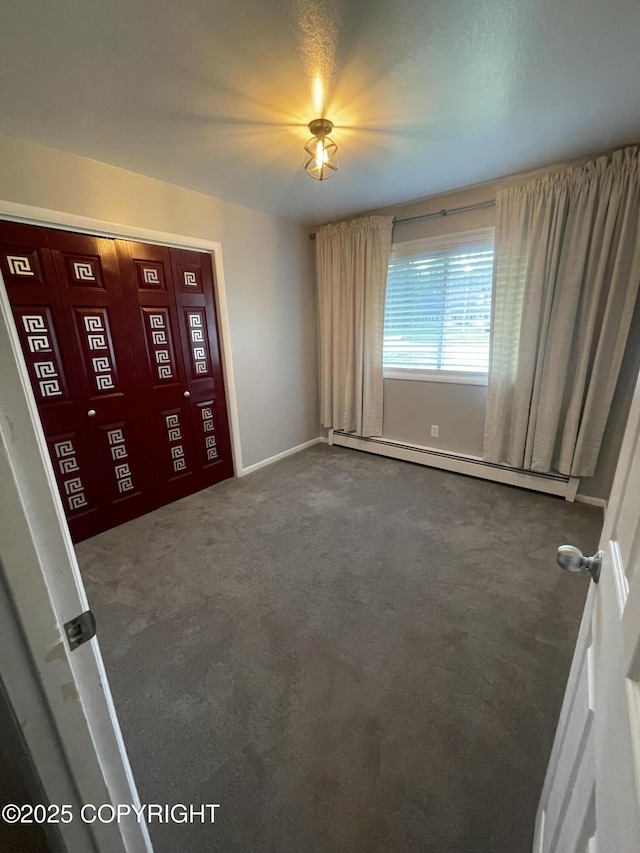 412 Pine Cir, Kenai, AK 99611 - empty room featuring baseboard heating, dark colored carpet, and baseboards