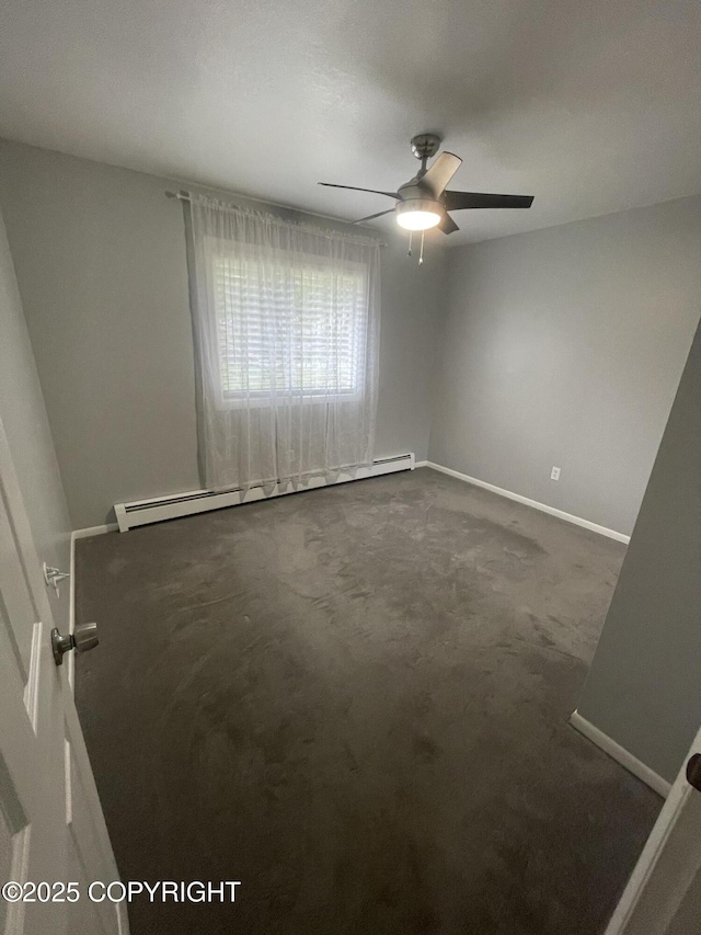 412 Pine Cir, Kenai, AK 99611 - unfurnished room featuring baseboards, dark colored carpet, a ceiling fan, and a baseboard heating unit