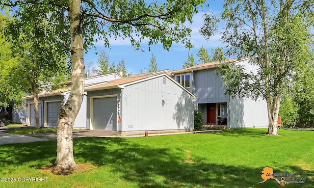 4147 Hampton Dr # 10D, Anchorage, AK 99504 - view of front facade featuring a front lawn and an attached garage