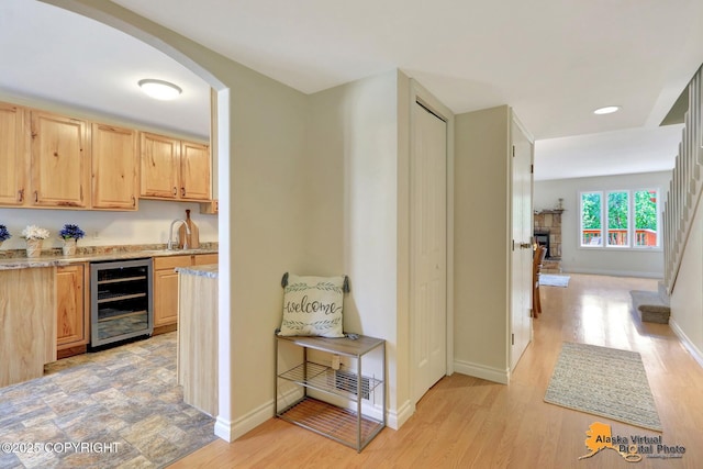 4147 Hampton Dr # 10D, Anchorage, AK 99504 - indoor wet bar with wine cooler, arched walkways, baseboards, light wood-type flooring, and recessed lighting