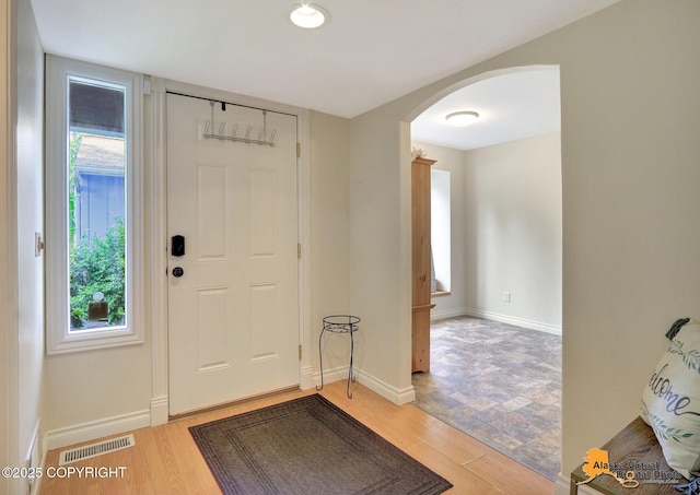 4147 Hampton Dr # 10D, Anchorage, AK 99504 - foyer featuring arched walkways, light wood-style floors, and baseboards