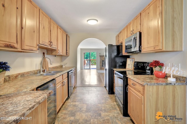 4147 Hampton Dr # 10D, Anchorage, AK 99504 - kitchen featuring black appliances, light brown cabinets, a sink, and arched walkways