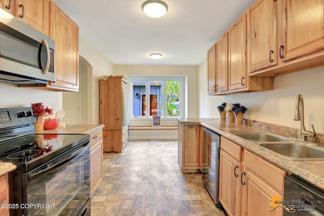 4147 Hampton Dr # 10D, Anchorage, AK 99504 - kitchen with black appliances, a sink, light countertops, stone finish floors, and arched walkways