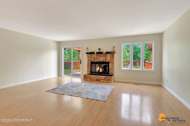 4147 Hampton Dr # 10D, Anchorage, AK 99504 - unfurnished living room featuring wood finished floors, a fireplace, and baseboards