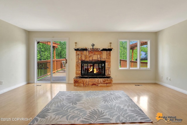 4147 Hampton Dr # 10D, Anchorage, AK 99504 - unfurnished living room with wood finished floors, a fireplace, and baseboards