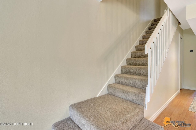 4147 Hampton Dr # 10D, Anchorage, AK 99504 - stairway featuring wood finished floors and baseboards