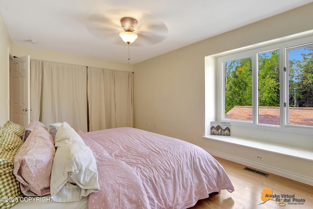 4147 Hampton Dr # 10D, Anchorage, AK 99504 - bedroom featuring wood finished floors, a ceiling fan, and baseboards