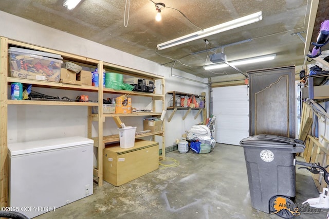 4147 Hampton Dr # 10D, Anchorage, AK 99504 - garage with white fridge and a garage door opener