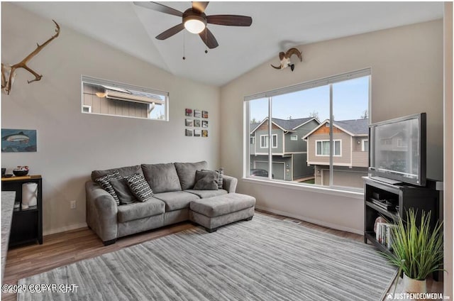 2370 Irontree Pl # 3, Anchorage, AK 99508 - living area featuring wood finished floors, vaulted ceiling, a ceiling fan, and baseboards