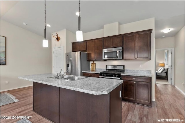 2370 Irontree Pl # 3, Anchorage, AK 99508 - kitchen featuring stainless steel appliances, baseboards, dark brown cabinetry, and a sink