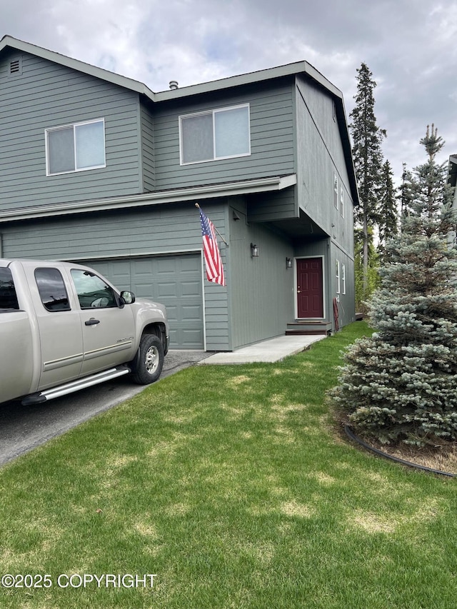 4766 Grumman St Unit 4766, Anchorage, AK 99507 - view of front of property featuring an attached garage, a front lawn, and asphalt driveway