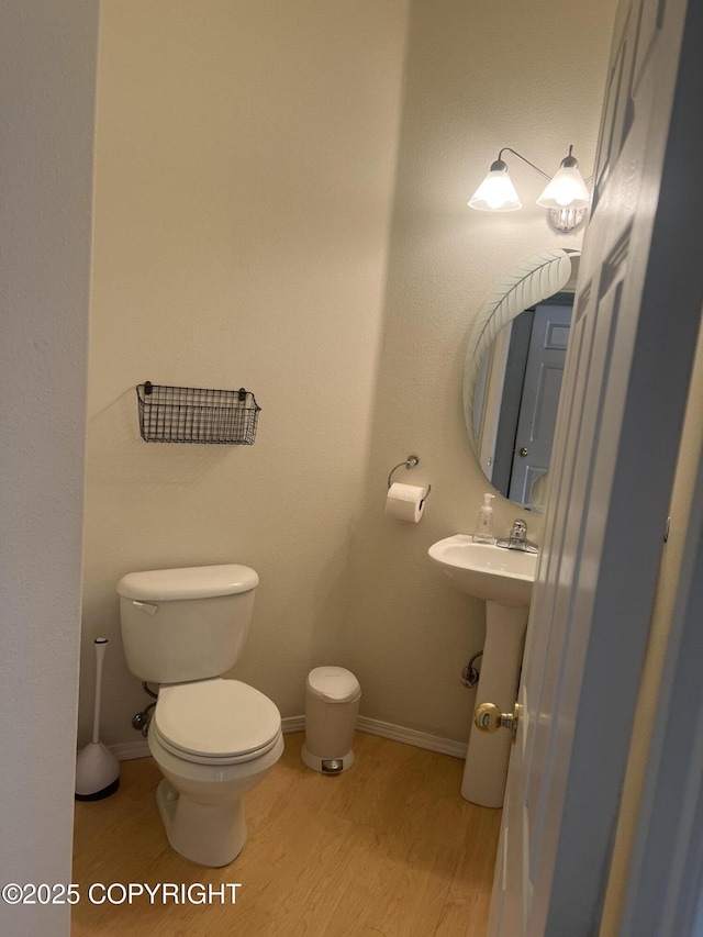 4766 Grumman St Unit 4766, Anchorage, AK 99507 - bathroom featuring wood finished floors, toilet, and baseboards