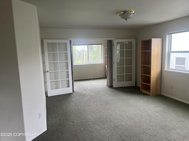 4766 Grumman St Unit 4766, Anchorage, AK 99507 - unfurnished bedroom featuring multiple windows, carpet, french doors, and baseboards
