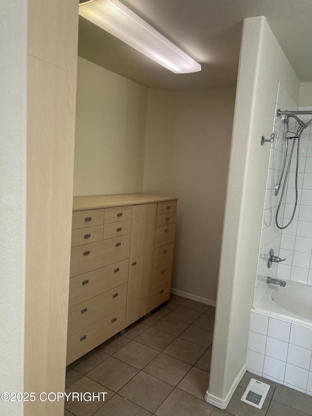 4766 Grumman St Unit 4766, Anchorage, AK 99507 - bathroom with tile patterned flooring, tiled shower / bath, and baseboards