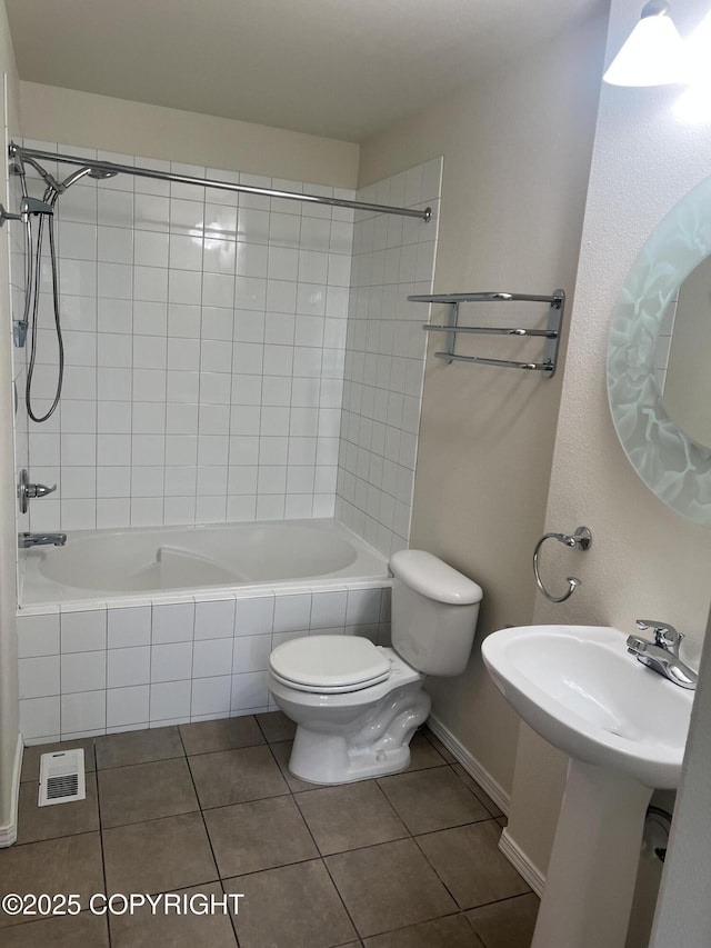 4766 Grumman St Unit 4766, Anchorage, AK 99507 - full bath with toilet, tile patterned flooring, tiled shower / bath combo, and baseboards