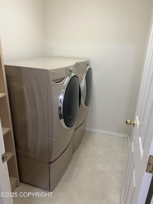 4766 Grumman St Unit 4766, Anchorage, AK 99507 - washroom featuring washer and clothes dryer, light tile patterned floors, and baseboards