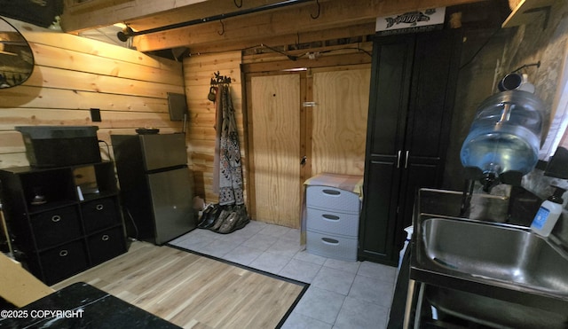 2246 S Fian Dr, Wasilla, AK 99654 - bathroom with wooden walls, a sink, and tile patterned floors