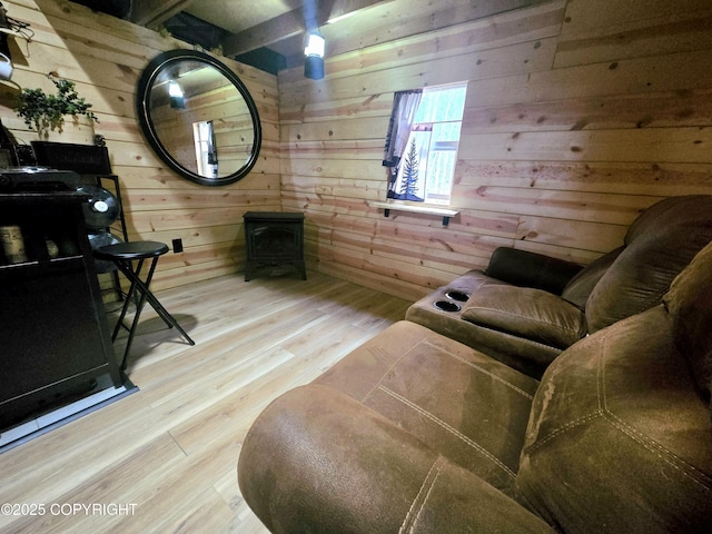 2246 S Fian Dr, Wasilla, AK 99654 - living area featuring a wood stove, wooden walls, and wood finished floors