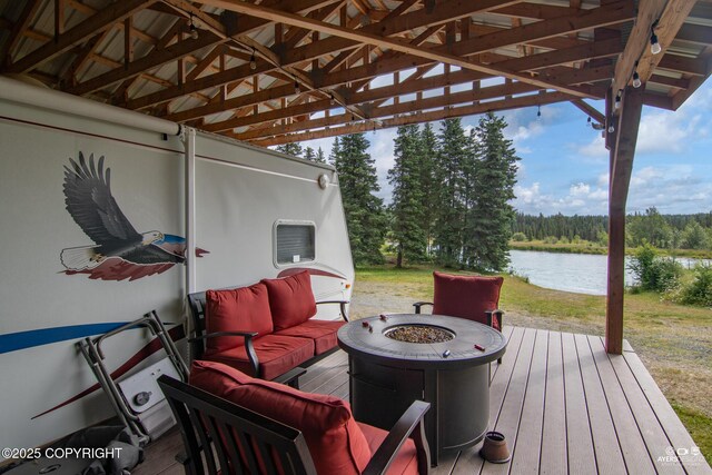 52619 Chumelina Ct, Kasilof, AK 99610 - wooden deck featuring a water view and an outdoor living space with a fire pit