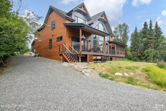 52619 Chumelina Ct, Kasilof, AK 99610 - view of front of property with stairway, central AC unit, a deck, and a sunroom