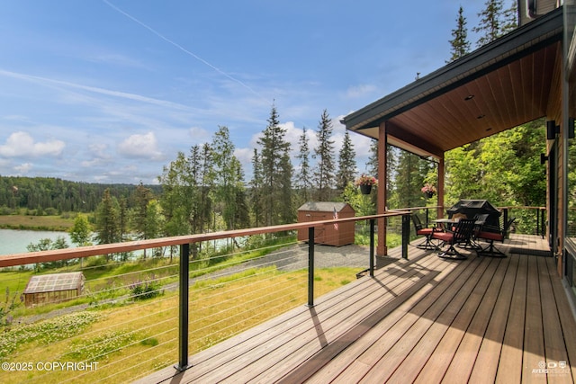 52619 Chumelina Ct, Kasilof, AK 99610 - wooden terrace featuring a water view, a wooded view, and grilling area