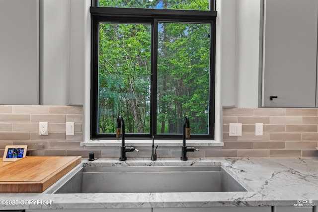 52619 Chumelina Ct, Kasilof, AK 99610 - kitchen with a sink, backsplash, and light stone countertops