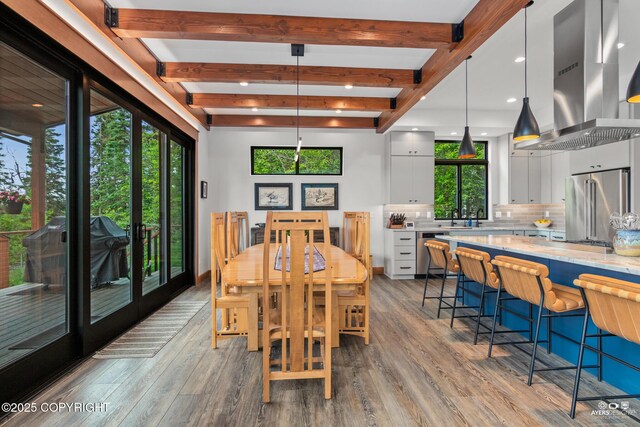 52619 Chumelina Ct, Kasilof, AK 99610 - dining area with healthy amount of natural light, wood finished floors, and beamed ceiling