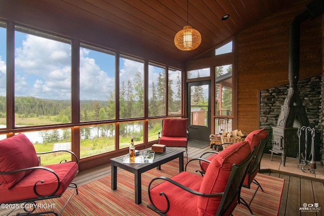 52619 Chumelina Ct, Kasilof, AK 99610 - sunroom / solarium featuring a wood stove, lofted ceiling, hardwood / wood-style flooring, and wood ceiling