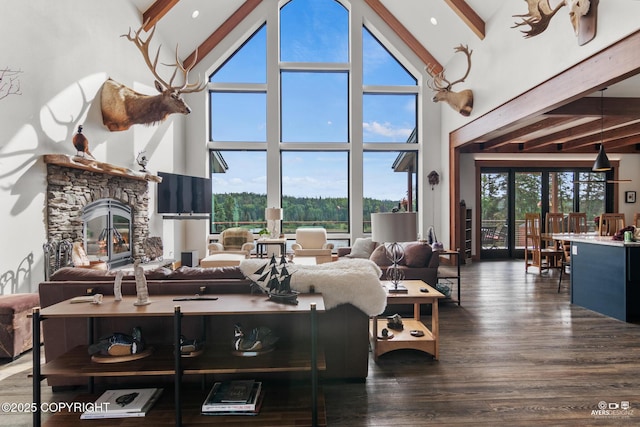 52619 Chumelina Ct, Kasilof, AK 99610 - living area with high vaulted ceiling, beamed ceiling, wood finished floors, and a fireplace
