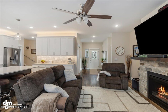 1630 S Corwin Ln, Wasilla, AK 99654 - living room featuring ceiling fan, a stone fireplace, light wood finished floors, and recessed lighting